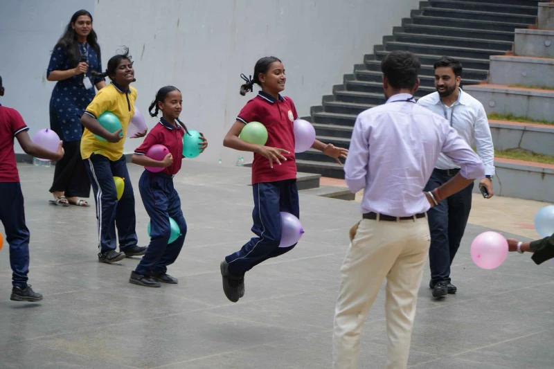 Students playing games with Dr. S.R. Sridhara Murthy at NSB Foundation Day 2026