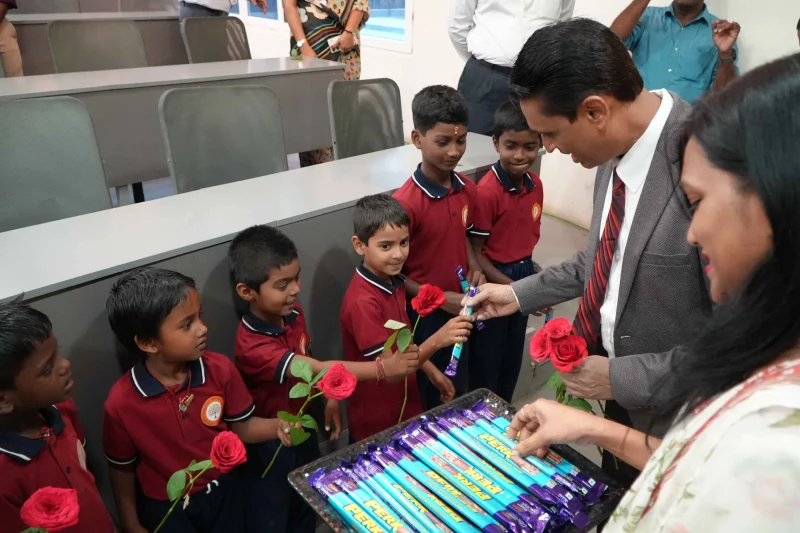 Students presenting flowers and receiving sweets at NSB Foundation Day 2026