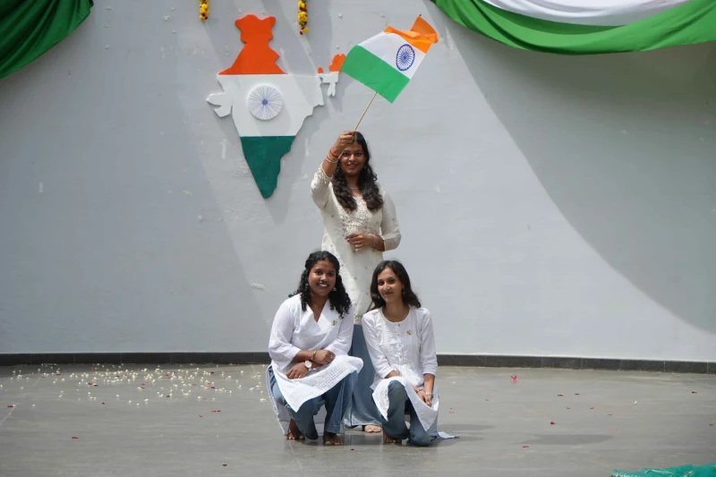 Students posing with the national flag at NSB Independence Day 2026 celebrations